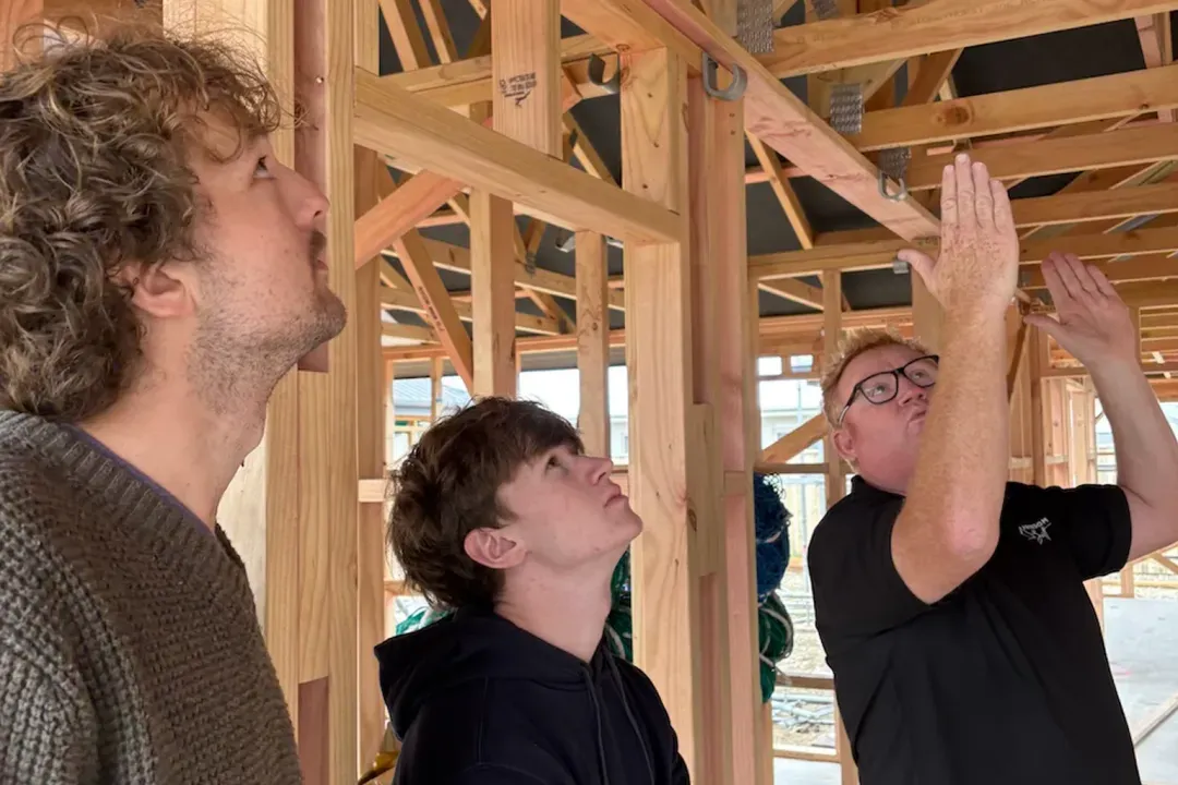TakeoffQS team inspecting a timber frame on site